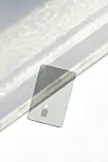 Modern bank card with chip resting on a bright surface with soft shadows